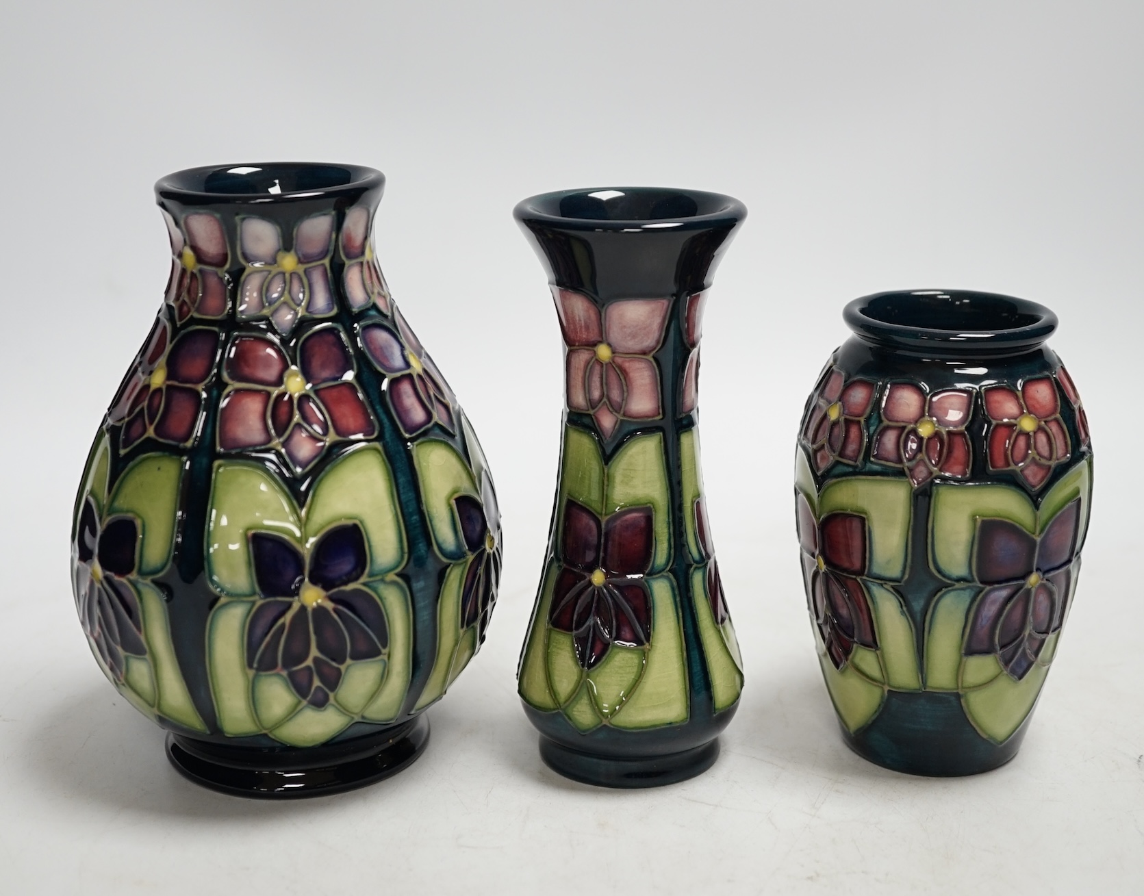 Three Moorcroft violet pattern vases, tallest 13.5cm